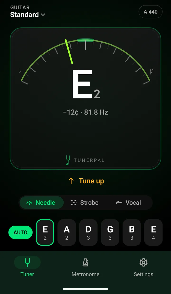 The Tuner tab in the Stage Pro theme: black background lit in green, the needle left of centre over E2 reading minus 12 cents and 81.8 Hz on the faceplate, Tune up, and a green AUTO chip