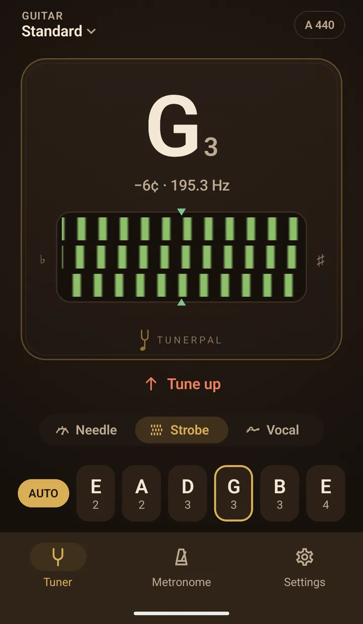 The strobe with the G string locked: G3 at minus 6 cents and 195.3 Hz, three rows of green bars on the faceplate, and Tune up